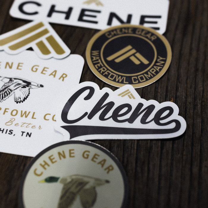 Chêne die-cut stickers scattered on dark wood, lifestyle detail