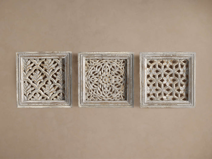 Set of 3 square, whitewashed Sukho Panels with intricate hand-carved designs, displayed horizontally on a beige wall.