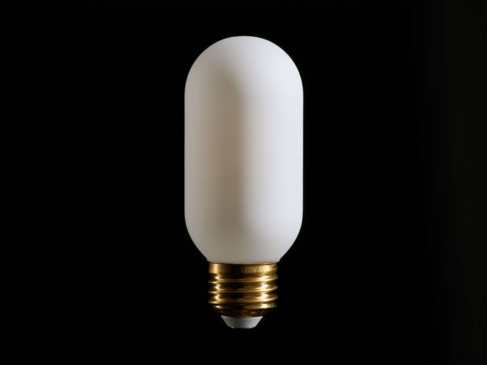 A white, cylindrical light bulb with a frosted surface and a brass screw base, centered against a black background.