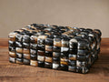 Tabor Box, a rectangular box with natural horn tiles in black, white, gray, and brown, on a wooden surface.