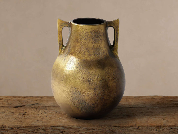 Taddeo Low Pot: Classically shaped antique brass cast aluminum pot with two handles, on a rustic wooden surface.