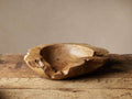 Rustic Teak Root Bowl, irregular, organic shape, natural wood tones, sitting on a weathered wooden surface.