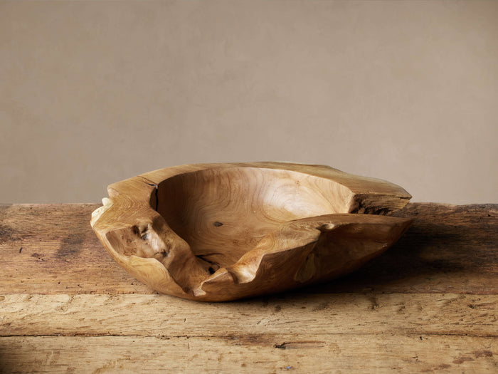 Rustic Teak Root Bowl, irregular, organic shape, natural wood tones, sitting on a weathered wooden surface.
