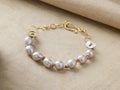 Thalassa Bracelet: White freshwater pearls, tan hemp cord, gold vermeil details, mother-of-pearl button accents, hook clasp on linen.