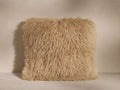 Square Tibetan Longwool Pillow in light sandy brown, covered in long, curly sheepskin, standing on a light background.