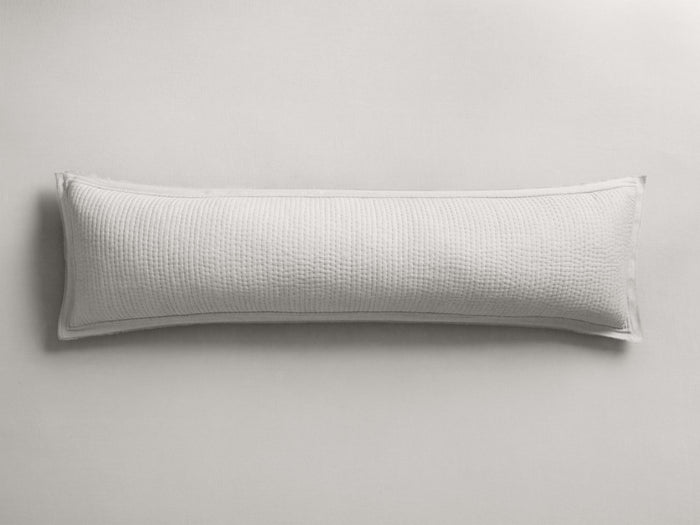 Horizontal off-white Tulaya Cotton Lumbar Pillow Cover, featuring a detailed quilted texture and frayed edge on a light background.