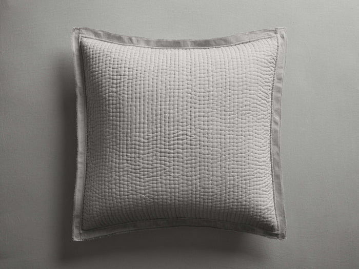 Light gray Tulaya Cotton Sham, square, featuring a subtle quilted pattern, soft wrinkles, and frayed edges, against a gray background.