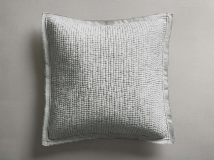 Tulaya Cotton Sham in light grey, featuring a square quilted texture and a 1-inch frayed edge, lying flat.