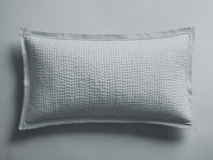 Light blue-grey Tulaya Cotton Sham with a quilted texture and frayed edges, lying flat against a matching background.