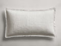Off-white Tulaya Cotton Sham, horizontally oriented, with a distinct quilted texture and elegant frayed edges.