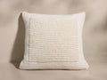 Front view of an off-white cushion with a thick ribbed texture and a raised square border around the central pattern.