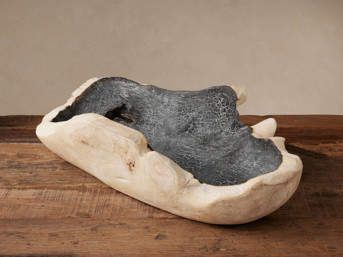 Organic Vanora Bowl made of light wood, featuring a dark, cracked interior, sitting on a rustic wooden table.
