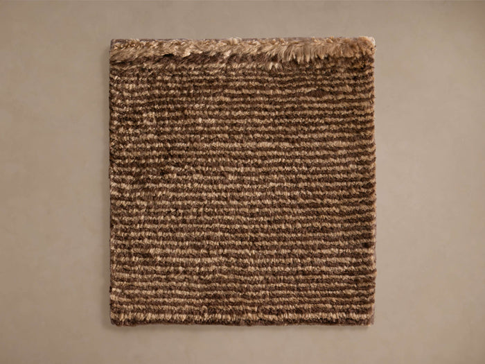 Vida Hand-Knotted Rug Swatch, a rectangular sample with textured light and dark brown stripes, laid flat on a neutral surface.