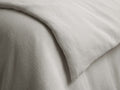 Washed Waffle Duvet in beige, showcasing a textured waffle-weave pattern. The duvet is layered, with visible knife-edge seam detail.