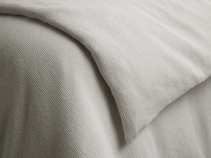 Washed Waffle Duvet in beige, showcasing a textured waffle-weave pattern. The duvet is layered, with visible knife-edge seam detail.