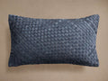 Horizontally oriented blue woven lumbar hide pillow with a prominent basket-weave pattern against a neutral background.